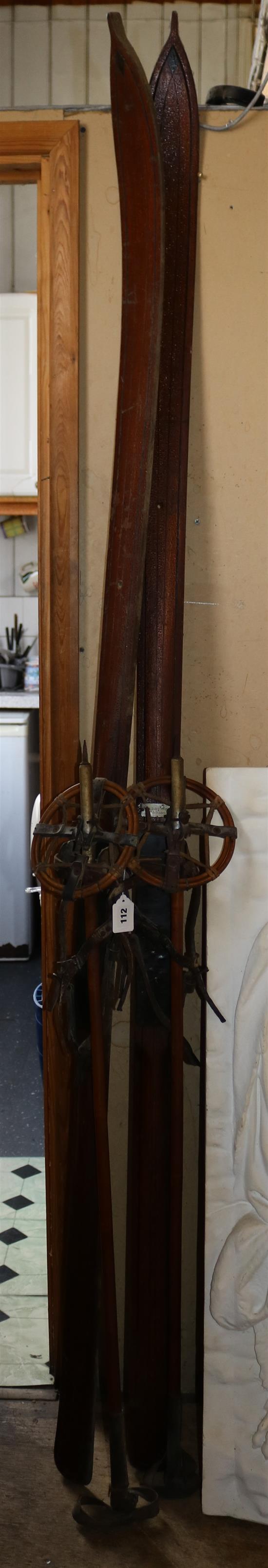 Pair of old wooden skis and sticks